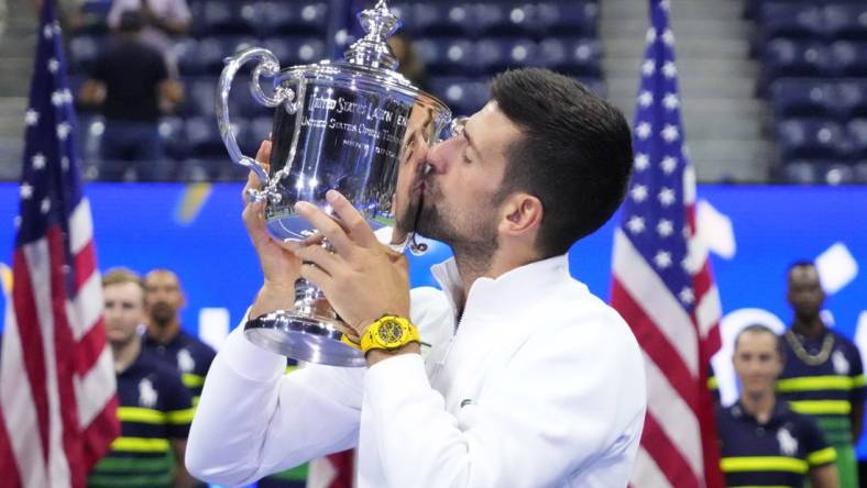 Sep 10, 2023; Flushing, NY, USA; Novak Djokovic of Serbia celebrates with the championship trophy after his match against Daniil Medvedev (not pictured) in the men's singles final on day fourteen of the 2023 U.S. Open tennis tournament at USTA Billie Jean King National Tennis Center. Mandatory Credit: Robert Deutsch-USA TODAY Sports