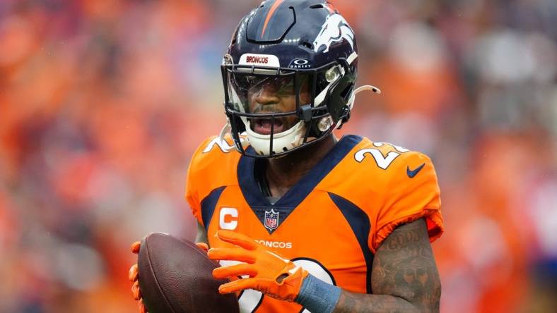 Sep 10, 2023; Denver, Colorado, USA; Denver Broncos safety Kareem Jackson (22) celebrates his turnover in the third quarter against the Las Vegas Raiders at Empower Field at Mile High. Mandatory Credit: Ron Chenoy-USA TODAY Sports