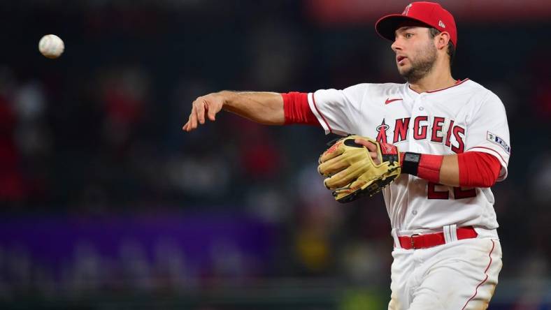 Sep 26, 2023; Anaheim, California, USA; Los Angeles Angels second baseman David Fletcher (22) throws to first for the out against Texas Rangers shortstop Josh Smith (47) during the seventh inning at Angel Stadium. Mandatory Credit: Gary A. Vasquez-USA TODAY Sports