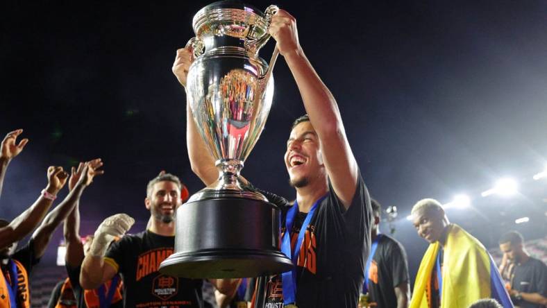 Sep 27, 2023; Fort Lauderdale, FL, USA; Houston Dynamo midfielder Amine Bassi (8) holds up the trophy after winning the Lamar Hunt U.S. Open Cup Final against Inter Miami CF at DRV PNK Stadium. Mandatory Credit: Nathan Ray Seebeck-USA TODAY Sports