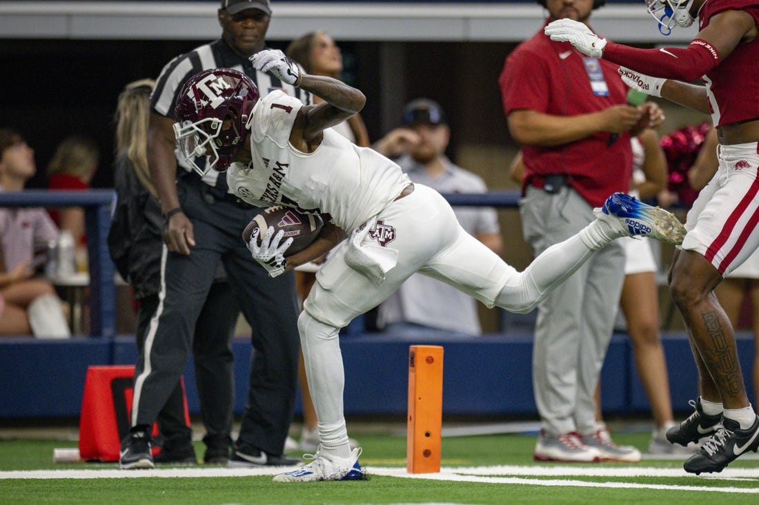 Sep 30, 2023; Arlington, Texas, USA;Texas A&M Aggies wide receiver Evan Stewart (1) scores a touchdown during the game between the Texas A&M Aggies and the Arkansas Razorbacks at AT&T Stadium. Mandatory Credit: Jerome Miron-USA TODAY Sports