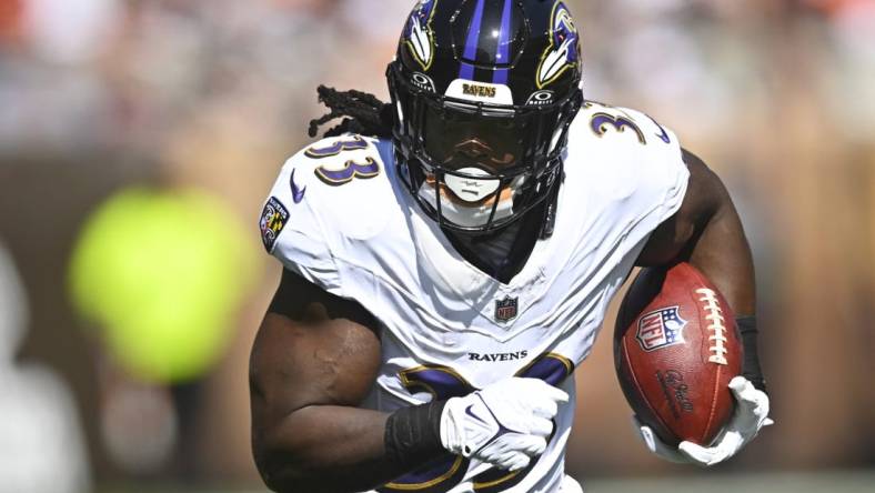 Oct 1, 2023; Cleveland, Ohio, USA; Baltimore Ravens running back Melvin Gordon III (33) runs with the ball in the second quarter against the Cleveland Browns at Cleveland Browns Stadium. Mandatory Credit: David Richard-USA TODAY Sports