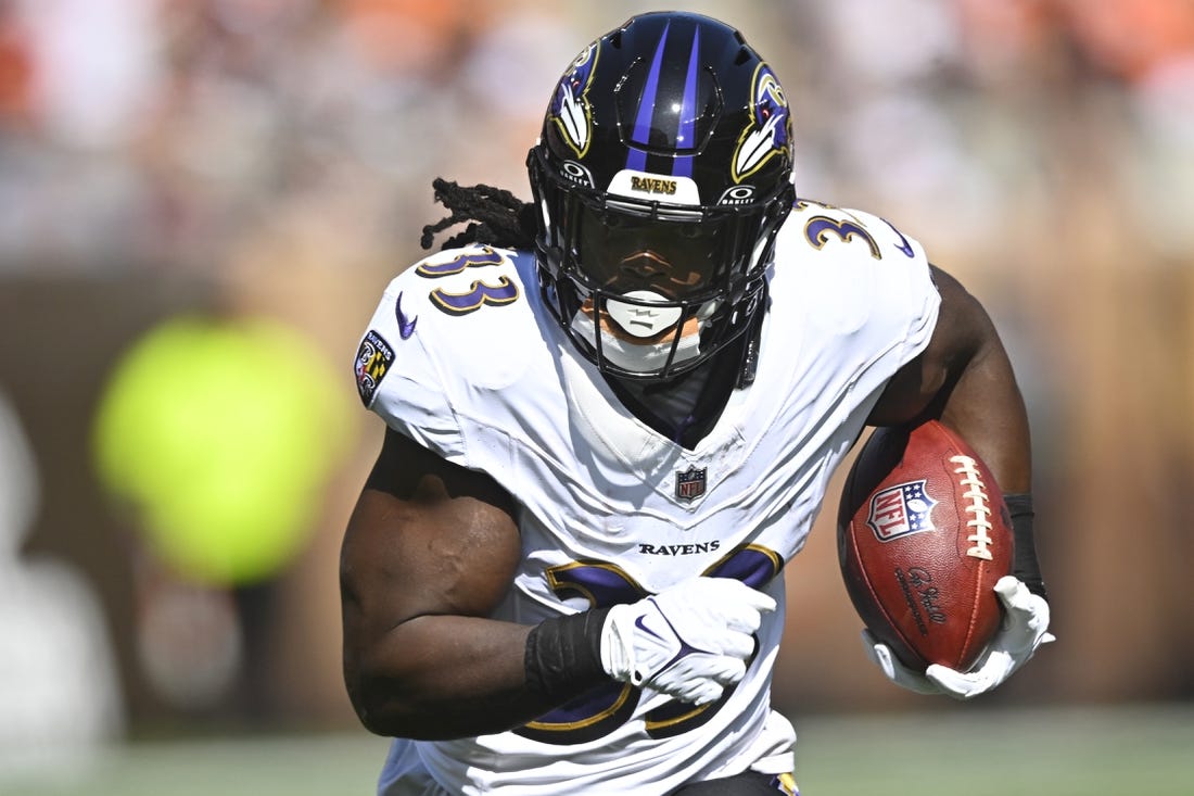Oct 1, 2023; Cleveland, Ohio, USA; Baltimore Ravens running back Melvin Gordon III (33) runs with the ball in the second quarter against the Cleveland Browns at Cleveland Browns Stadium. Mandatory Credit: David Richard-USA TODAY Sports