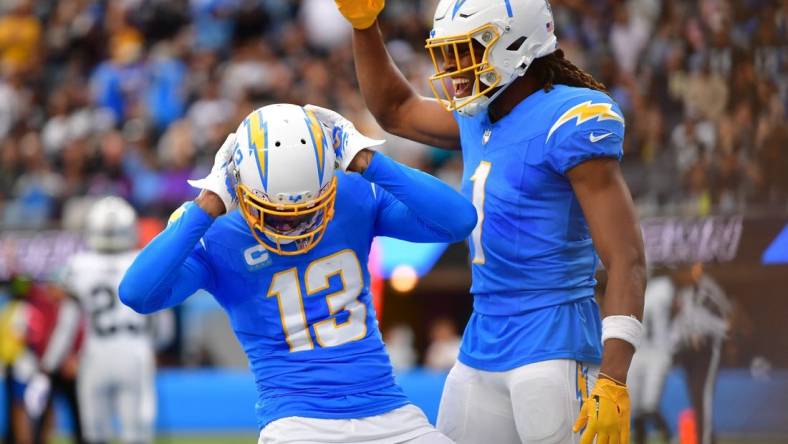 Oct 1, 2023; Inglewood, California, USA; Los Angeles Chargers wide receiver Keenan Allen (13) celebrates his touchdown scored against the Las Vegas Raiders with wide receiver Quentin Johnston (1) during the first half at SoFi Stadium. Mandatory Credit: Gary A. Vasquez-USA TODAY Sports