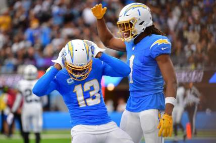 Oct 1, 2023; Inglewood, California, USA; Los Angeles Chargers wide receiver Keenan Allen (13) celebrates his touchdown scored against the Las Vegas Raiders with wide receiver Quentin Johnston (1) during the first half at SoFi Stadium. Mandatory Credit: Gary A. Vasquez-USA TODAY Sports