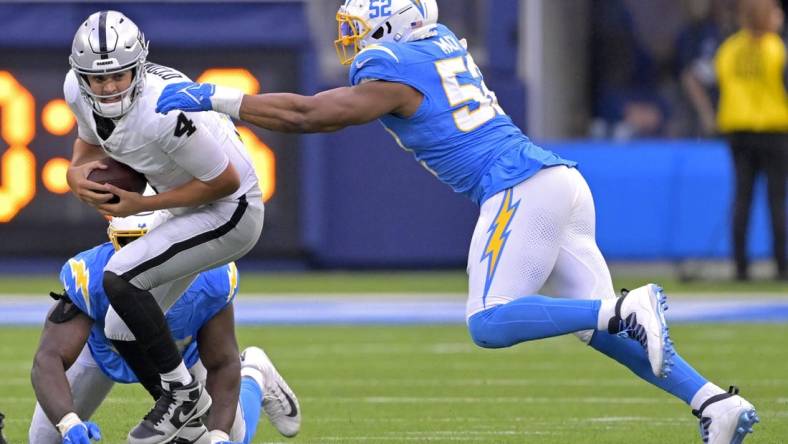 Oct 1, 2023; Inglewood, California, USA;  Las Vegas Raiders quarterback Aidan O'Connell (4) escapes the grasp of Los Angeles Chargers defensive tackle Sebastian Joseph-Day (51) but is sacked by linebacker Khalil Mack (52) in the second half at SoFi Stadium. Mandatory Credit: Jayne Kamin-Oncea-USA TODAY Sports