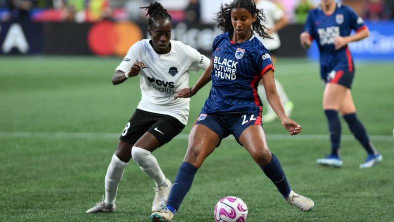 Oct 6, 2023; Seattle, Washington, USA; Washington Spirit forward Ouleymata Sarr (8) and OL Reign defender Ryanne Brown (22) battle for the ball during the second half at Lumen Field. Mandatory Credit: Steven Bisig-USA TODAY Sports