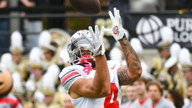 Oct 14, 2023; West Lafayette, Indiana, USA;  Ohio State Buckeyes wide receiver Julian Fleming (4) catches a pass during warmups prior to the game at Ross-Ade Stadium. Mandatory Credit: Robert Goddin-USA TODAY Sports