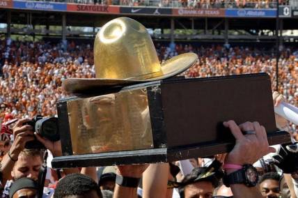 The Golden Hat Trophy is raised after the Red River Rivalry college football game between the University of Oklahoma Sooners (OU) and the University of Texas (UT) Longhorns at the Cotton Bowl in Dallas, Saturday, Oct. 7, 2023. Oklahoma won 34-30.