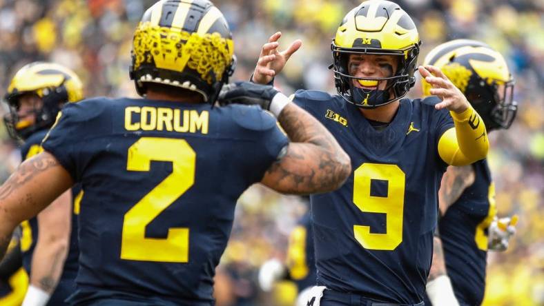 Michigan quarterback J.J. McCarthy celebrates a touchdown against Indiana scored by running back Blake Corum during the first half of U-M's 52-7 win over Indiana on Saturday, Oct. 14, 2023, in Ann Arbor.