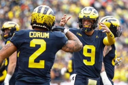Michigan quarterback J.J. McCarthy celebrates a touchdown against Indiana scored by running back Blake Corum during the first half of U-M's 52-7 win over Indiana on Saturday, Oct. 14, 2023, in Ann Arbor.