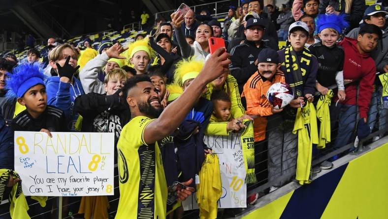 Oct 14, 2023; Nashville, Tennessee, USA; Nashville SC midfielder Anibal Godoy (20) celebrates with fans after the game against New England Revolution at Geodis Park. Mandatory Credit: Christopher Hanewinckel-USA TODAY Sports