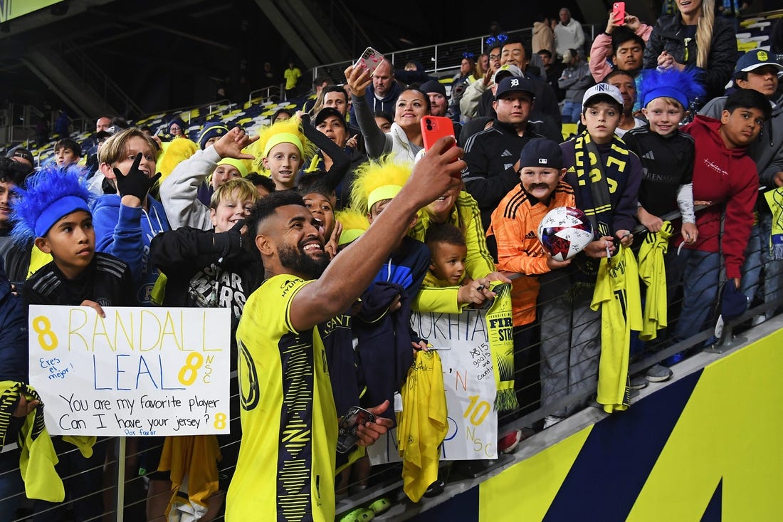 Oct 14, 2023; Nashville, Tennessee, USA; Nashville SC midfielder Anibal Godoy (20) celebrates with fans after the game against New England Revolution at Geodis Park. Mandatory Credit: Christopher Hanewinckel-USA TODAY Sports