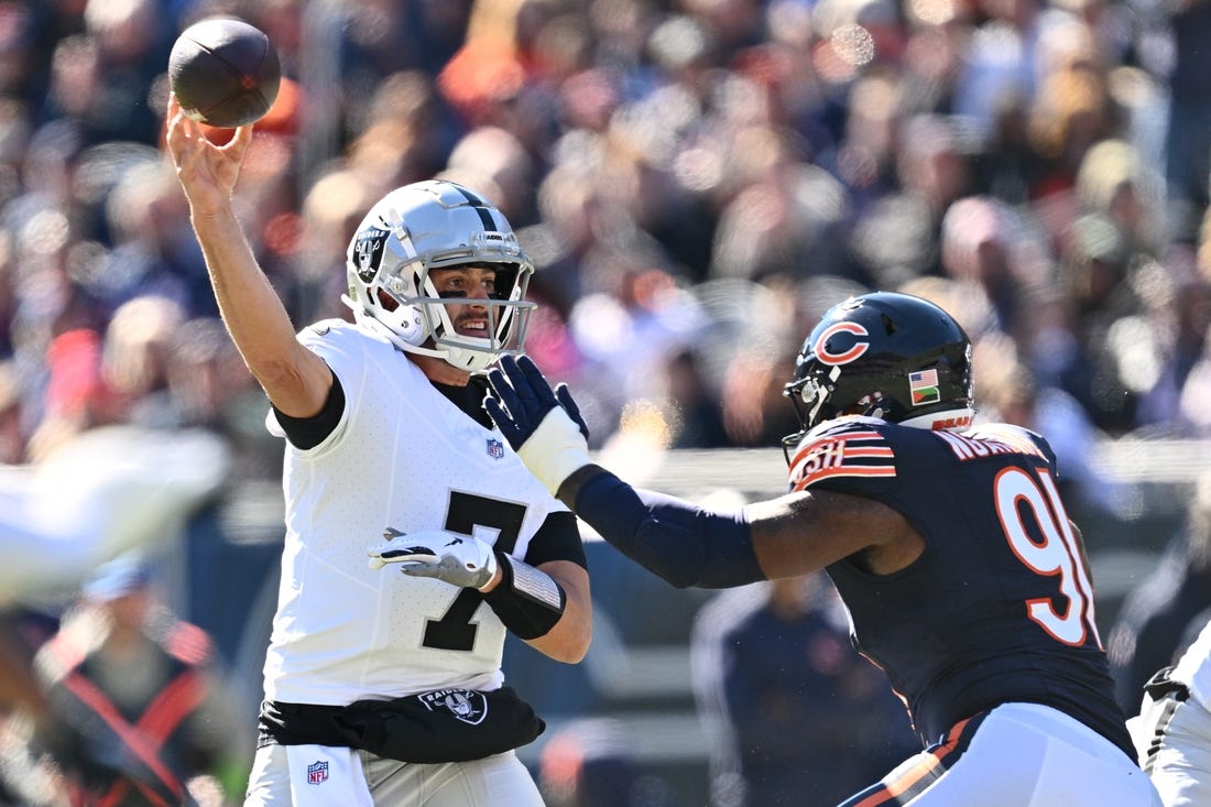 Oct 22, 2023; Chicago, Illinois, USA;  Las Vegas Raiders quarterback Brian Hoyer (7) gets off a pass while being pressured by Chicago Bears defensive lineman Yannick Ngakoue (91) in the second quarter at Soldier Field. Mandatory Credit: Jamie Sabau-USA TODAY Sports