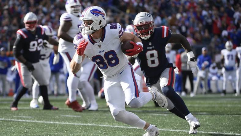 Oct 22, 2023; Foxborough, Massachusetts, USA; Buffalo Bills tight end Dawson Knox (88) runs the ball while New England Patriots linebacker Ja'Whaun Bentley (8) defends during the second half at Gillette Stadium. Mandatory Credit: Bob DeChiara-USA TODAY Sports