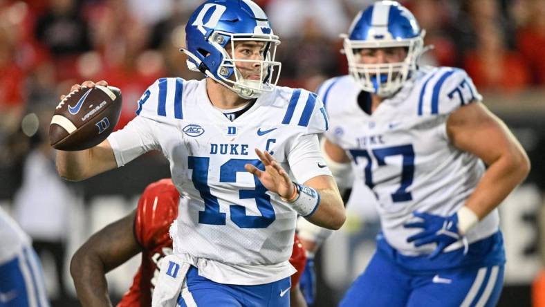 Oct 28, 2023; Louisville, Kentucky, USA;  Duke Blue Devils quarterback Riley Leonard (13) looks to pass the ball against the Louisville Cardinals during the second half at L&N Federal Credit Union Stadium. Mandatory Credit: Jamie Rhodes-USA TODAY Sports