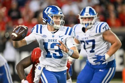 Oct 28, 2023; Louisville, Kentucky, USA;  Duke Blue Devils quarterback Riley Leonard (13) looks to pass the ball against the Louisville Cardinals during the second half at L&N Federal Credit Union Stadium. Mandatory Credit: Jamie Rhodes-USA TODAY Sports