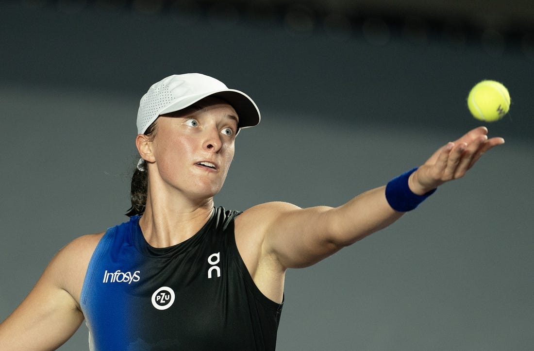 Oct 30, 2023; Cancun, Mexico;  Iga Swiatek (POL) tosses the ball to serve during her match against Marketa Vondrousova (CZE) on day two of the GNP Saguaros WTA Finals Cancun. Mandatory Credit: Susan Mullane-USA TODAY Sports