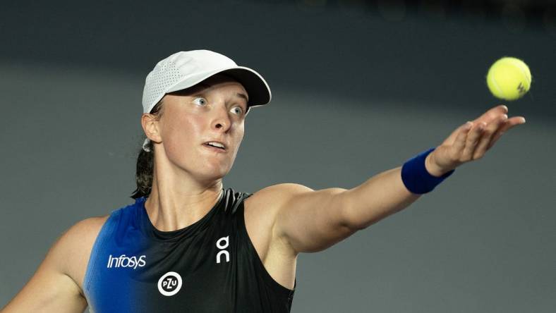 Oct 30, 2023; Cancun, Mexico;  Iga Swiatek (POL) tosses the ball to serve during her match against Marketa Vondrousova (CZE) on day two of the GNP Saguaros WTA Finals Cancun. Mandatory Credit: Susan Mullane-USA TODAY Sports