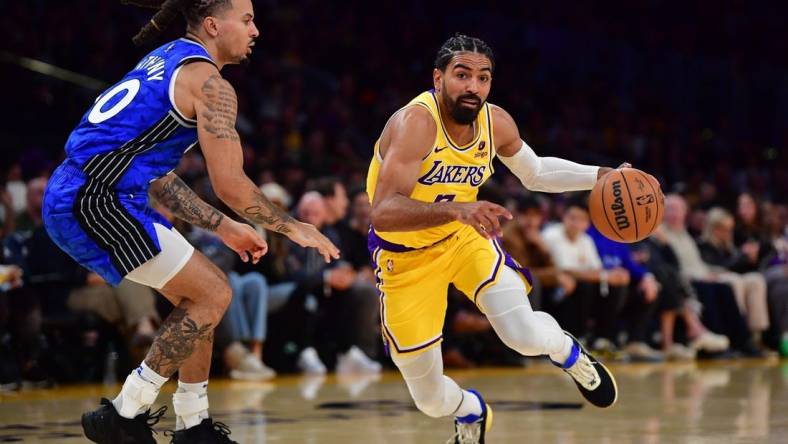 Oct 30, 2023; Los Angeles, California, USA; Los Angeles Lakers guard Gabe Vincent (7) moves to the basket against Orlando Magic guard Cole Anthony (50) during the second half at Crypto.com Arena. Mandatory Credit: Gary A. Vasquez-USA TODAY Sports