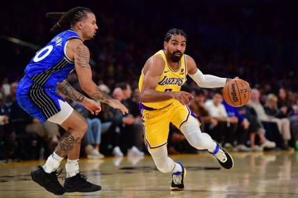 Oct 30, 2023; Los Angeles, California, USA; Los Angeles Lakers guard Gabe Vincent (7) moves to the basket against Orlando Magic guard Cole Anthony (50) during the second half at Crypto.com Arena. Mandatory Credit: Gary A. Vasquez-USA TODAY Sports