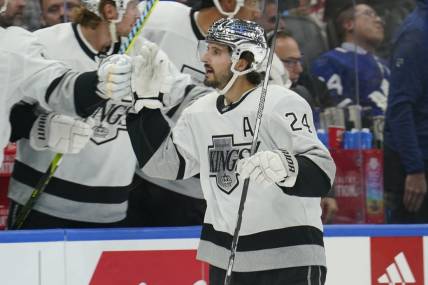 Oct 31, 2023; Toronto, Ontario, CAN; Los Angeles  Kings forward Phillip Danault (24) gets congratulated after scoring against the Toronto Maple Leafs during the first period at Scotiabank Arena. Mandatory Credit: John E. Sokolowski-USA TODAY Sports