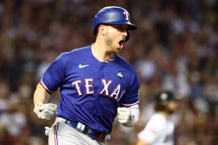 Nov 1, 2023; Phoenix, Arizona, USA; Texas Rangers catcher Mitch Garver (18) reacts after hitting a RBI single against the Arizona Diamondbacks during the sixth inning in game five of the 2023 World Series at Chase Field. Mandatory Credit: Mark J. Rebilas-USA TODAY Sports