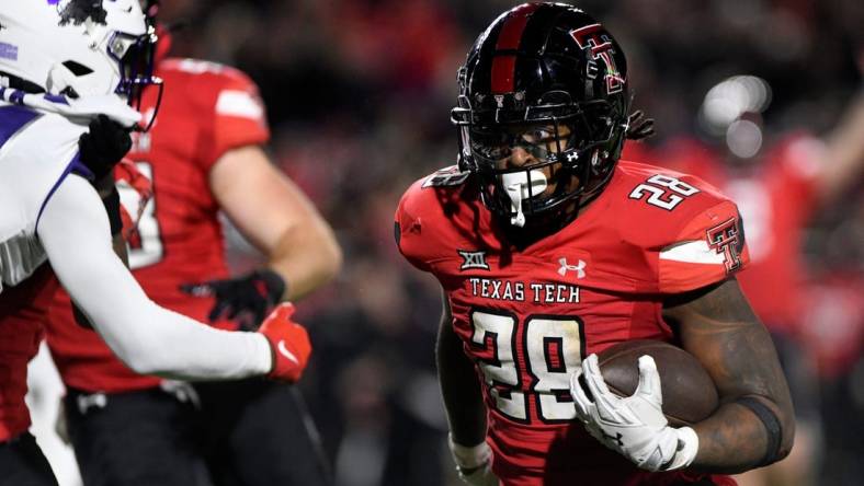 Texas Tech's running back Tahj Brooks (28) runs for a touchdown against TCU in a Big 12 football game, Thursday, Nov. 2, 2023, at Jones AT&T Stadium.