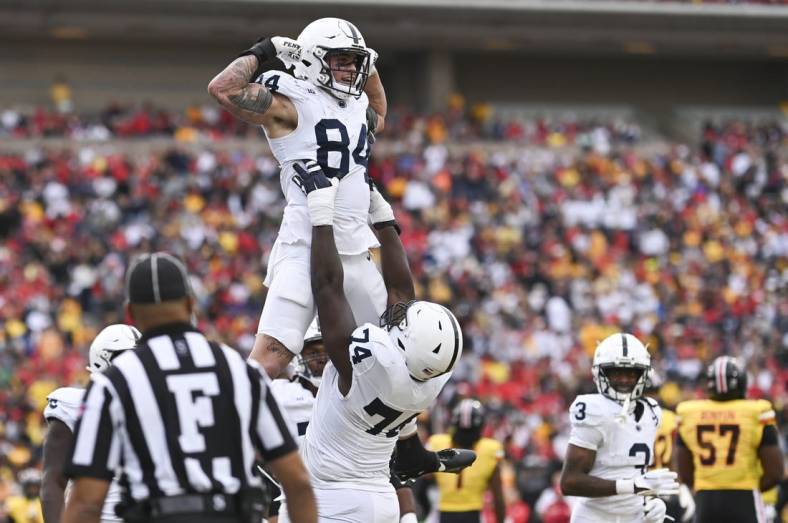 Nov 4, 2023; College Park, Maryland, USA;  Penn State Nittany Lions offensive lineman Olumuyiwa Fashanu (74) celebrates with  tight end Theo Johnson (84) after scoring a first half touchdown against the Maryland Terrapins at SECU Stadium. Mandatory Credit: Tommy Gilligan-USA TODAY Sports