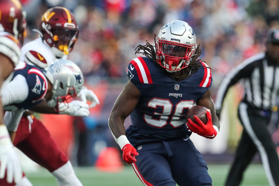 Nov 5, 2023; Foxborough, Massachusetts, USA; New England Patriots running back Rhamondre Stevenson (38) runs the ball during the second half against the Washington Commanders at Gillette Stadium. Mandatory Credit: Paul Rutherford-USA TODAY Sports