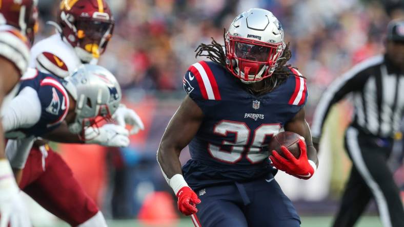 Nov 5, 2023; Foxborough, Massachusetts, USA; New England Patriots running back Rhamondre Stevenson (38) runs the ball during the second half against the Washington Commanders at Gillette Stadium. Mandatory Credit: Paul Rutherford-USA TODAY Sports