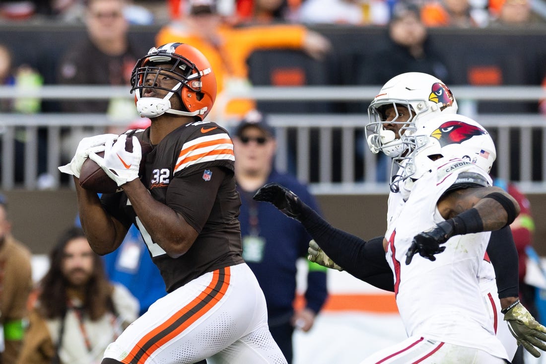 Nov 5, 2023; Cleveland, Ohio, USA; Cleveland Browns wide receiver Amari Cooper (2) makes a reception for a first down under coverage by Arizona Cardinals cornerback Antonio Hamilton Sr. (33) and safety Budda Baker (3) during the fourth quarter at Cleveland Browns Stadium. Mandatory Credit: Scott Galvin-USA TODAY Sports