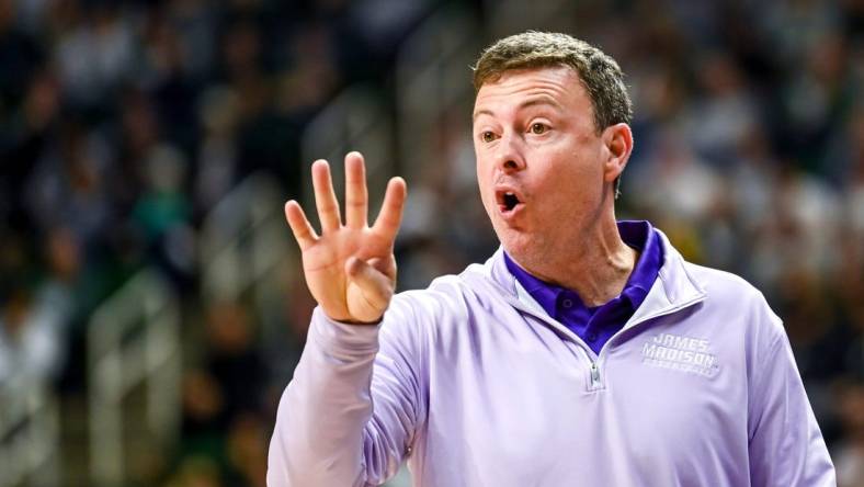 James Madison's head coach Mark Byington talks to a referee during the first half in the game against Michigan State on Monday, Nov. 6, 2023, in East Lansing.