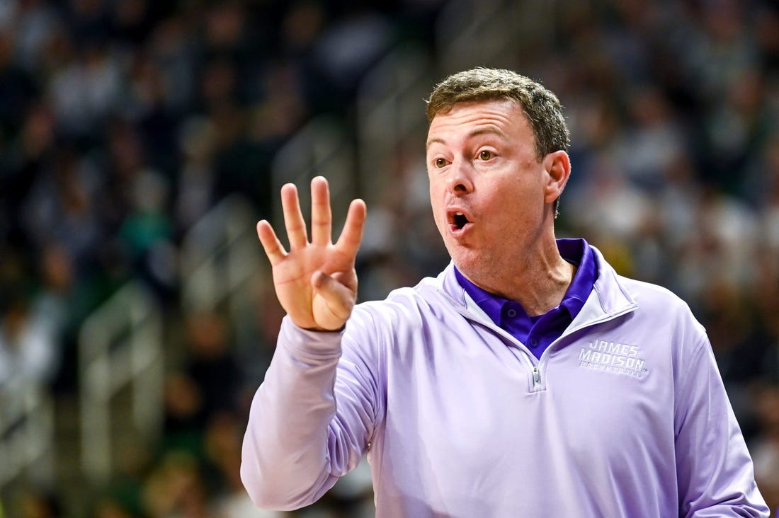 James Madison's head coach Mark Byington talks to a referee during the first half in the game against Michigan State on Monday, Nov. 6, 2023, in East Lansing.