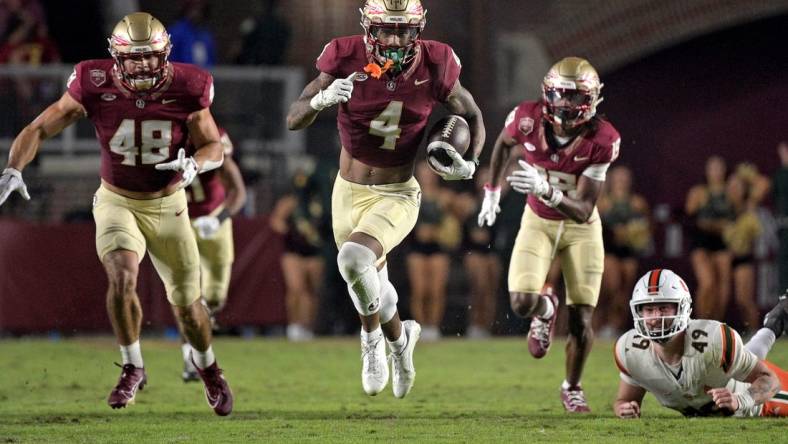 Nov 11, 2023; Tallahassee, Florida, USA; Florida State Seminoles wide receiver Keon Coleman (4) returns a punt in the second half against the Miami Hurricanes at Doak S. Campbell Stadium. Mandatory Credit: Melina Myers-USA TODAY Sports