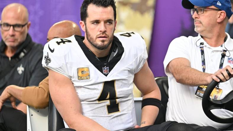 Nov 12, 2023; Minneapolis, Minnesota, USA; New Orleans Saints quarterback Derek Carr (4) is carted off the field after an injury against the Minnesota Vikings during the thrid quarter at U.S. Bank Stadium. Mandatory Credit: Jeffrey Becker-USA TODAY Sports