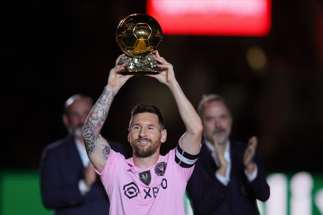 Nov 10, 2023; Lauderdale, FL, USA; Inter Miami forward Lionel Messi (10) poses with the Ballon d'Or trophy before the game against New York City at DRV PNK Stadium. Mandatory Credit: Sam Navarro-USA TODAY Sports