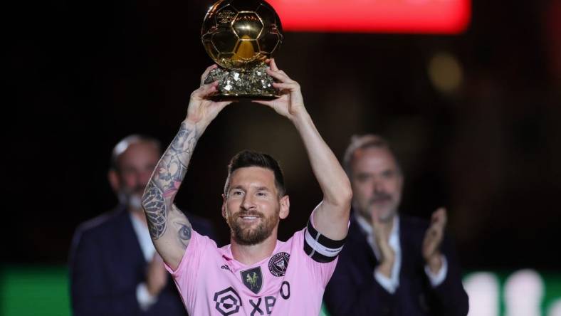 Nov 10, 2023; Lauderdale, FL, USA; Inter Miami forward Lionel Messi (10) poses with the Ballon d'Or trophy before the game against New York City at DRV PNK Stadium. Mandatory Credit: Sam Navarro-USA TODAY Sports