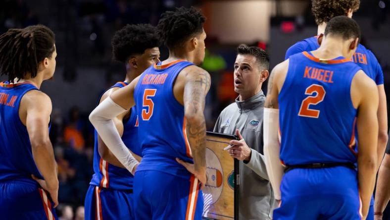 Nov 17, 2023; Gainesville, Florida, USA; Florida Gators head coach Todd Golden talks with Florida Gators guard Zyon Pullin (0), Florida Gators guard Walter Clayton Jr. (1), Florida Gators guard Will Richard (5), and Florida Gators guard Riley Kugel (2) during the second half against the Florida State Seminoles at Exactech Arena at the Stephen C. O'Connell Center. Mandatory Credit: Matt Pendleton-USA TODAY Sports