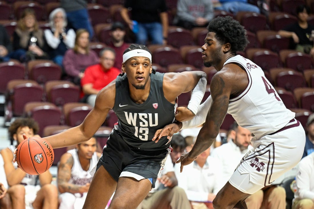 Nov 18, 2023; Uncasville, CT, USA; Washington State Cougars forward Isaac Jones (13) dribbles the ball defended by Washington State Cougars guard Shae Korpela (4) during the first half at Mohegan Sun Arena. Mandatory Credit: Mark Smith-USA TODAY Sports