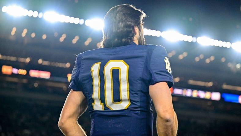 Nov 18, 2023; South Bend, Indiana, USA; Notre Dame Fighting Irish quarterback Sam Hartman (10) watches from the bench in the fourth quarter against the Wake Forest Demon Deacons at Notre Dame Stadium. Mandatory Credit: Matt Cashore-USA TODAY Sports