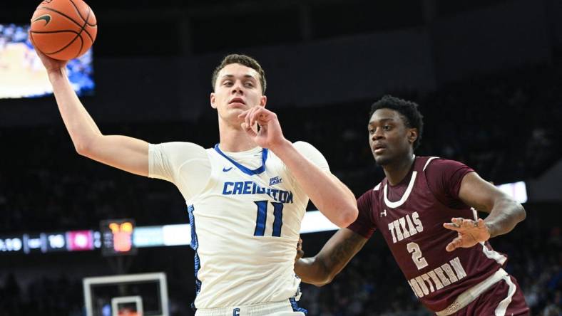 Nov 18, 2023; Omaha, Nebraska, USA;  Creighton Bluejays center Ryan Kalkbrenner (11) looks to drive against Texas Southern Tigers forward Jahmar Young Jr. (2) in the first half at CHI Health Center Omaha. Mandatory Credit: Steven Branscombe-USA TODAY Sports