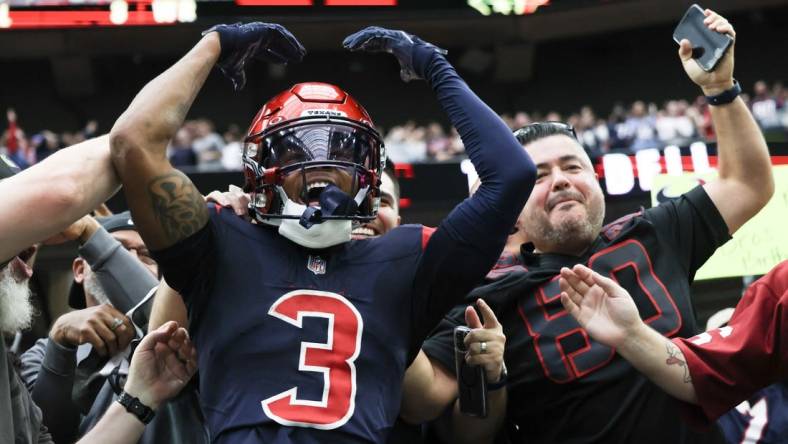 Nov 19, 2023; Houston, Texas, USA;  Houston Texans wide receiver Tank Dell (3) jumps in the stands and celebrates his touchdown against the Arizona Cardinals in the second quarter at NRG Stadium. Mandatory Credit: Thomas Shea-USA TODAY Sports