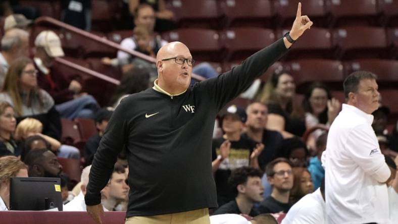 Nov 19, 2023; Charleston, SC, USA; Wake Forest Demon Deacons head coach Steve Forbes sends a play in the first half against the LSU Tigers at TD Arena. Mandatory Credit: David Yeazell-USA TODAY Sports