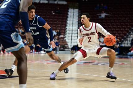 Nov 19, 2023; Uncasville, CT, USA; Washington State Cougars guard Myles Rice (2) dribbles the ball defended by Rhode Island Rams guard Luis Kortright (1) during the second half at Mohegan Sun Arena. Mandatory Credit: Mark Smith-USA TODAY Sports