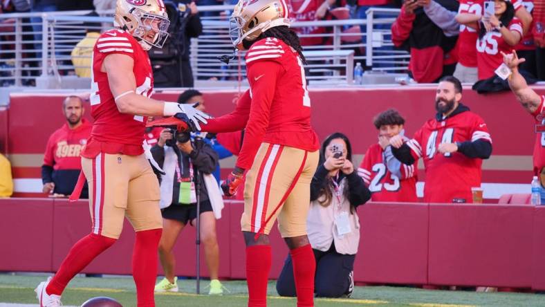 Nov 19, 2023; Santa Clara, California, USA; San Francisco 49ers wide receiver Brandon Aiyuk (11) celebrates with fullback Kyle Juszczyk (44) after scoring a 76-yard touchdown against the Tampa Bay Buccaneers during the third quarter at Levi's Stadium. Mandatory Credit: Kelley L Cox-USA TODAY Sports