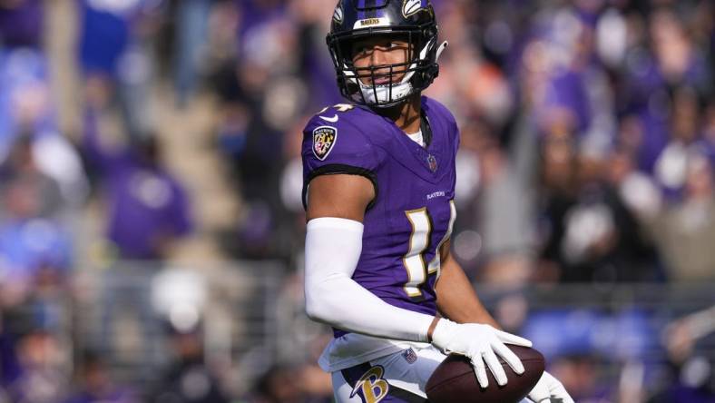 Nov 12, 2023; Baltimore, Maryland, USA;  Baltimore Ravens safety Kyle Hamilton (14) celebrates after scoring a touchdown against the Cleveland Browns during the first quarter at M&T Bank Stadium. Mandatory Credit: Jessica Rapfogel-USA TODAY Sports