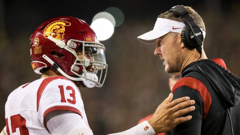 USC Trojans quarterback Caleb Williams talks with USC Trojans head coach Lincoln Riley during the first half of the game against No. 6 Oregon Ducks on Saturday, Nov. 11, 2023, at Autzen Stadium in Eugene, Ore.