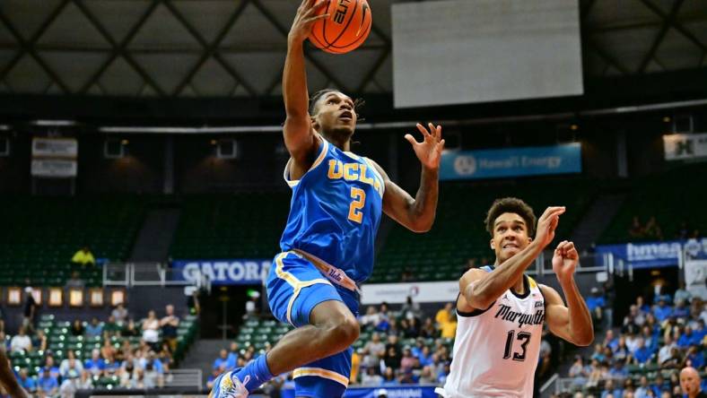 Nov 20, 2023; Honolulu, Hawaii, USA;  UCLA Bruins guard Dylan Andrews (2) drives to the basket against Marquette Golden Eagles forward Oso Ighodaro (13) during the first period at SimpliFi Arena at Stan Sheriff Center. Mandatory Credit: Steven Erler-USA TODAY Sports