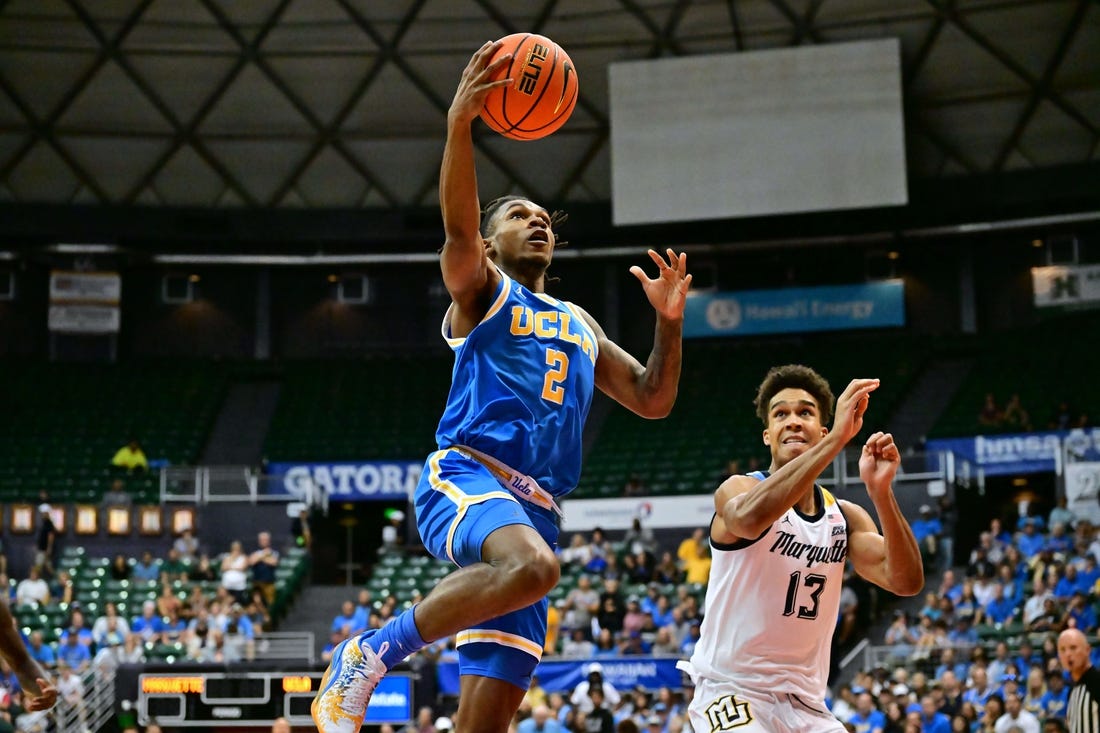 Nov 20, 2023; Honolulu, Hawaii, USA;  UCLA Bruins guard Dylan Andrews (2) drives to the basket against Marquette Golden Eagles forward Oso Ighodaro (13) during the first period at SimpliFi Arena at Stan Sheriff Center. Mandatory Credit: Steven Erler-USA TODAY Sports